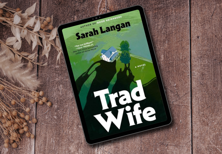 The cover for the book Trad Wife by Sarah Langan. the cover features a house in a green pastures. Shadows are moving towards the house to engulf it.